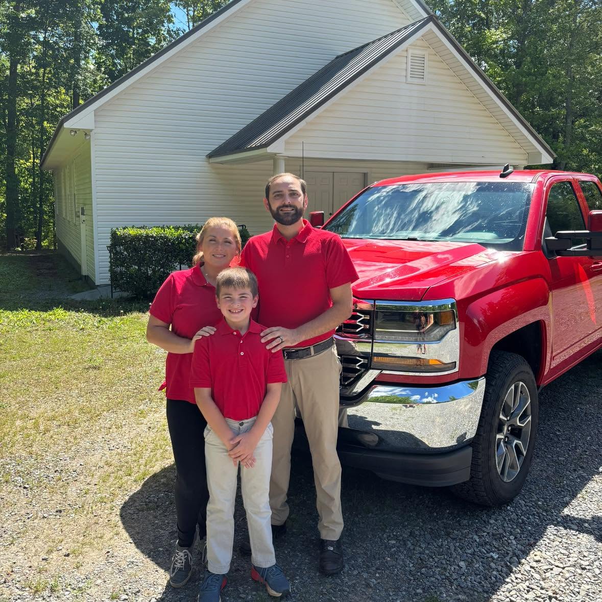 Jordan Morris and the JM Advanced Appliance Repair team beside their red service truck