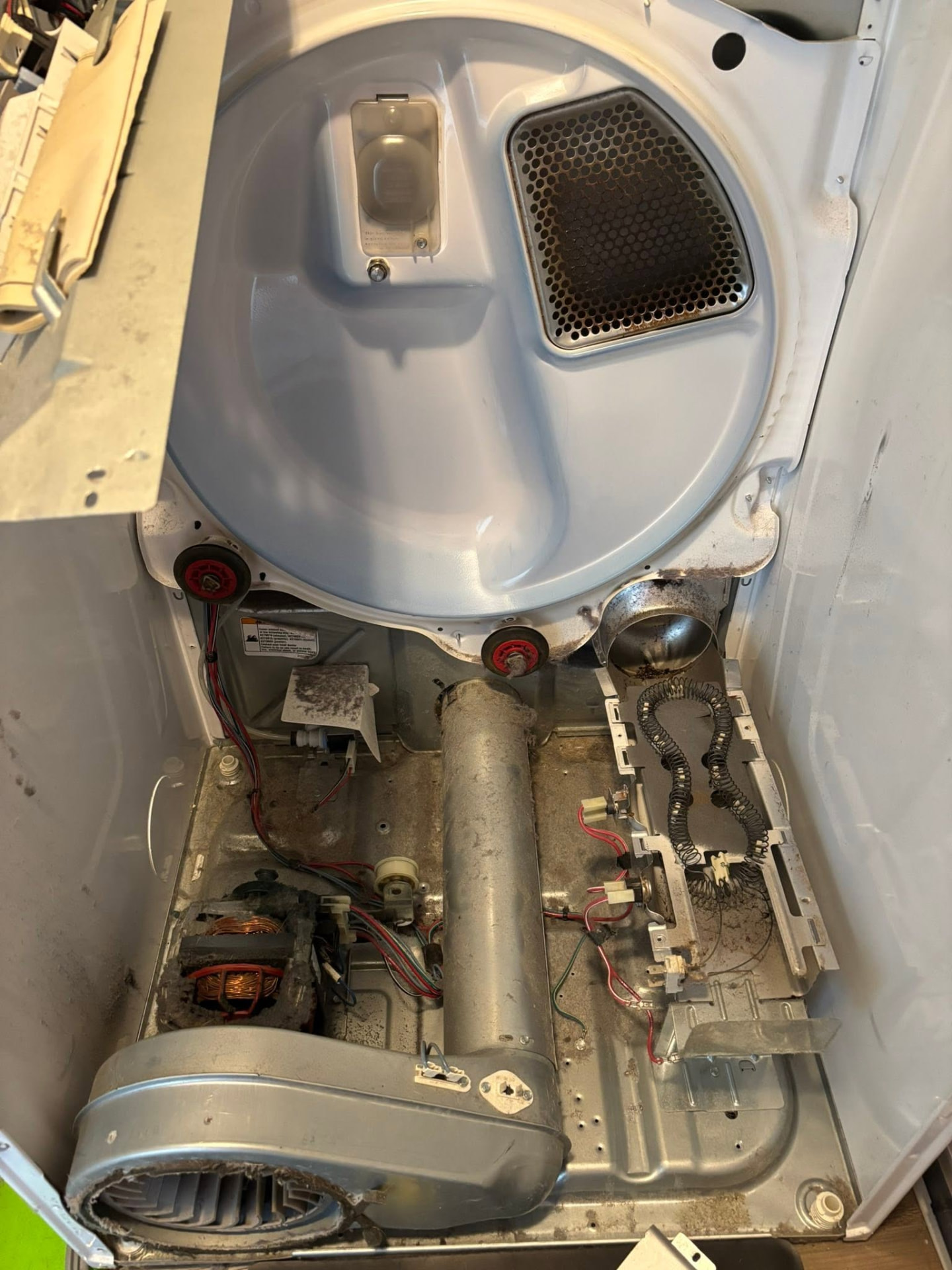 Open dryer interior before cleaning and repair work